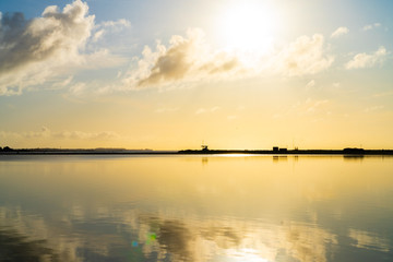The colorful sky at the ocean refleceted in the water