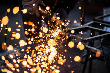 Sparks fly into the camera. Metal processing.