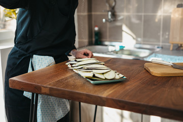 Female chef seasoning meal with eggplant