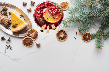 top view of christmas cocktail with orange, pomegranate, cinnamon and pie on tray
