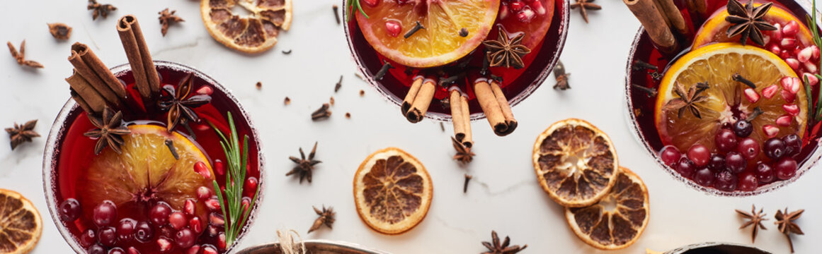 Panoramic Shot Of Christmas Cocktails With Orange, Pomegranate, Cinnamon