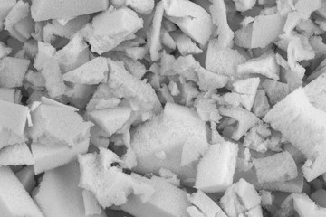 white polyurethane foam rubber pieces background texture. stuffing for pillows and furniture