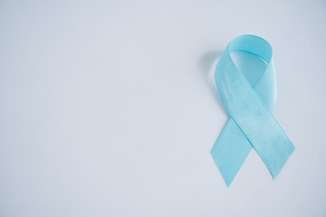 blue awareness ribbon on white background with copy space