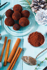 Christmas chocolate truffles and spices on shabby chic blue wood table