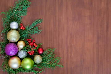 Christmas wooden background with fir branches and balls. New Year's decoration.
