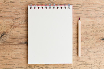 Office desk table with blank notebook. Top view with copy space, flat lay.