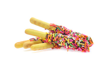 Biscuit stick bread with sweet colorful chocolate isolated on white background