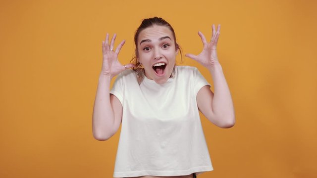 Young girl screams of excitement and delight as she is surprised by something special. It's a feeling of hurrah as she is so happy and enchanted at the same time.
