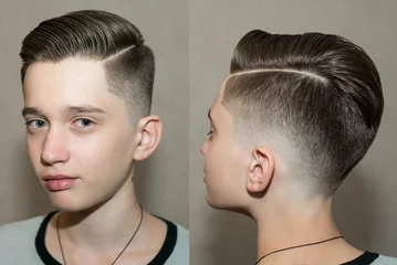 Fotobehang Kapsalon Stylish modern retro haircut side part with mid fade with parting of a school boy guy in a barbershop on a brown background  © vika33