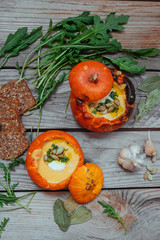 Pumpkin soup served in a small pumpkins. autumn dish. Still life, top view,