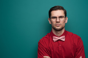 Portrait of a serious young man in a red shirt