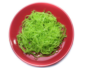 green noodles on dish isolated on white background