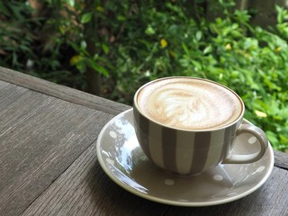 Hot coffee latte on a wooden table.