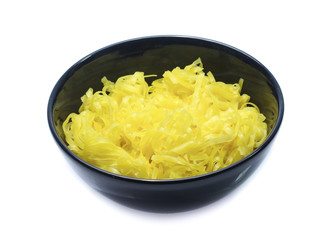 yellow noodles on bowl isolated on white background