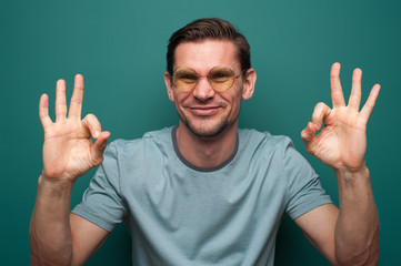 Portrait of a positive young man in glasses