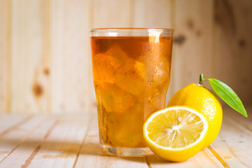 Glasses of ice tea with lemon slices  on wooden background
