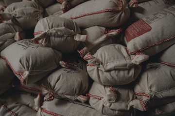 Fototapeta na wymiar Pile of rice sacks in grain warehouse