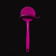 Bright yellow plastic kitchen utensils - cooking concept. Flat lay image of ladle, whisk, skimmer spoon and spatulas with copy space. Upside position of kitchenware on turquoise blue background