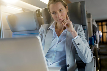 businesswoman working on a train in business class