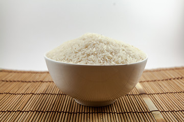 Jasmine rice cultivated in Thailand is in a white cup,isolated white background