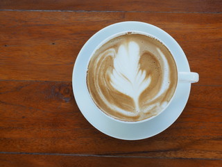 Hot coffee latte on a wooden table, Top view