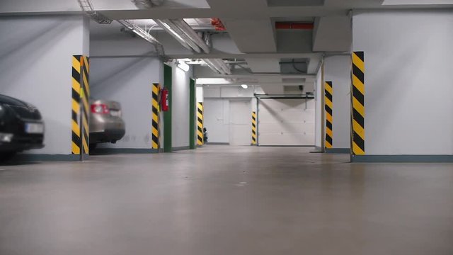 child rides on a gyroscooter in a parking garage in the underground garage