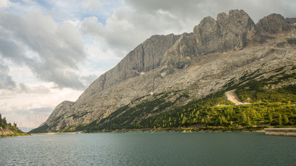 Beautiful panoramic view of Fedaia Lake (Lago di Fedaia), Italian Alps, Dolomites (Dolomiti). Italy, Europe.