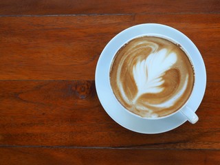 Hot coffee latte on a wooden table, Top view