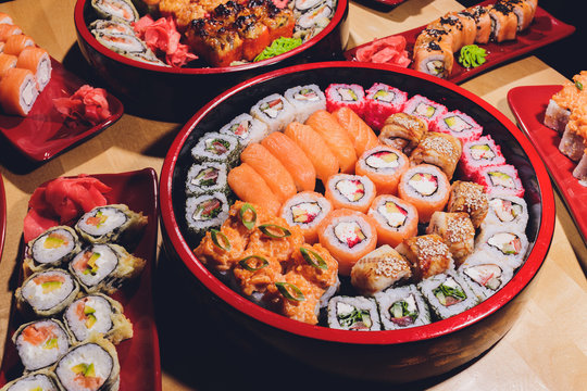 Photo of fresh maki sushi platter with a lot of variety. Selective focus on middle of the platter.