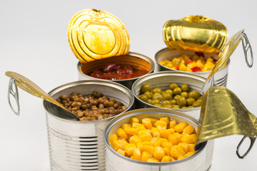 Canned food on white background. Green pea, beans, corn, lentils.