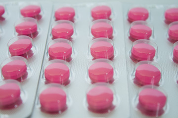 pink pills on white background