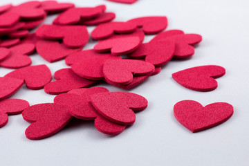 Obraz premium Red crafting foam hearts in white background. Decor hearts by cutting from red crafting foam