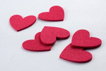 Obraz premium Red crafting foam hearts in white background. Decor hearts by cutting from red crafting foam