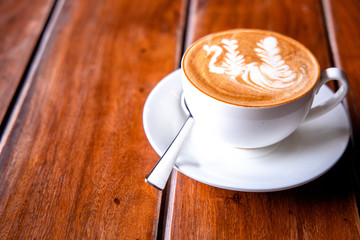 A cup of coffee presented on a wooden surface