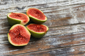 Sliced fig fruits. Decorative wooden background texture. Super foods concept. Organic food.