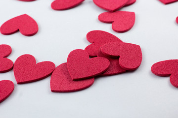 Red crafting foam hearts in white background. Decor hearts by cutting from red crafting foam