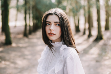 Beautiful dreamy girl portrait. Romantic portrait of a beautiful girl in the park