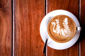 A cup of coffee presented on a wooden surface