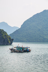 A local ship sailing in Ha-Long Bay, Vietnam