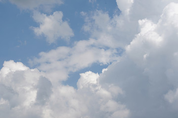 Large white fluffy clouds with a beautiful blue sky.