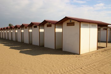 Naklejka premium Beach huts on the famous Lido beach in Venice, in the low season in october. Lido di Venezia, Italy, Europe.
