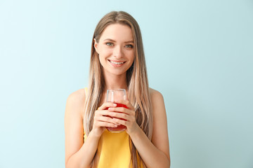 Woman with healthy juice on light background. Diet concept