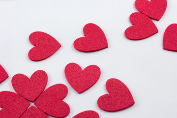 Obraz premium Red crafting foam hearts in white background. Decor hearts by cutting from red crafting foam