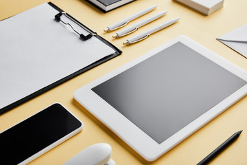 clipboard, pens, pencil, business cards, smartphone and digital tablet with copy space