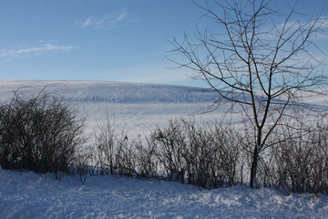 Winter landscape image with snow on the hill, trees, and bushes. Pennsylvania winter.