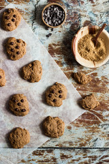whole grain crakers over an oven paper with some of the ingredients aside