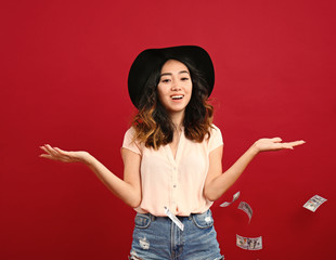 Asian woman with flying money on color background