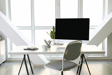 Comfortable workplace in light modern office