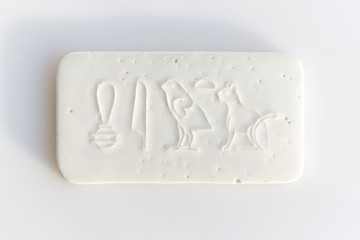 clay tablet with the inscription cat in ancient egyptian. modern handwork. hieroglyph cat