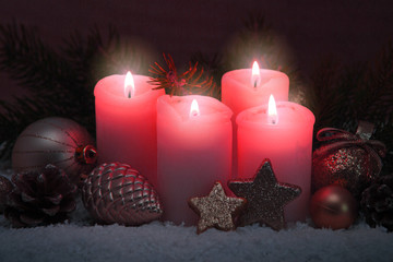 Four pink burning advent candles. Christmas card.